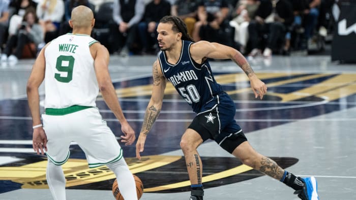 Orlando Magic guard Cole Anthony (50) drives past Boston Celtics guard Derrick White (9) in the team's win over the Celtics earlier this season